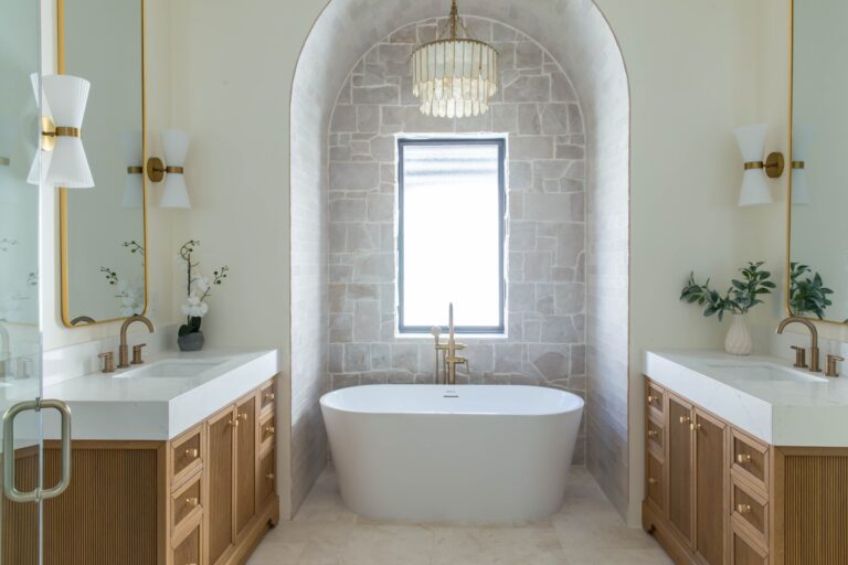 Arched stone tub niche with double oak vanities by All-Pro Cabinets, Jacksonville FL